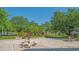 Beautiful outdoor patio area with stone tables and benches, surrounded by lush greenery at 19325 Water Oak Dr # 305, Port Charlotte, FL 33948