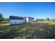 Exterior of a home with a shed and spacious grass backyard at 22220 Lasalle Rd, Port Charlotte, FL 33952
