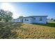 Exterior of a home with a shed and a spacious backyard with grass at 22220 Lasalle Rd, Port Charlotte, FL 33952