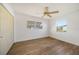 Bedroom featuring wood flooring, ceiling fan, two windows, and a closet at 22220 Lasalle Rd, Port Charlotte, FL 33952