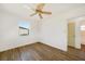 Bedroom featuring wood flooring, a window, and ceiling fan at 22220 Lasalle Rd, Port Charlotte, FL 33952