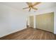 Bedroom featuring wood flooring, ceiling fan, a closet, and a doorway at 22220 Lasalle Rd, Port Charlotte, FL 33952