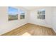 Bedroom featuring wood flooring and windows offering plenty of natural light at 22220 Lasalle Rd, Port Charlotte, FL 33952