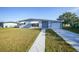 Charming single-story home featuring a well-maintained lawn and neutral paint at 22220 Lasalle Rd, Port Charlotte, FL 33952