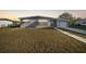 Charming single-story home featuring an attached garage and a well-maintained front lawn at 22220 Lasalle Rd, Port Charlotte, FL 33952