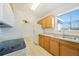 Bright kitchen featuring wood cabinets, tile flooring and view to dining area at 22220 Lasalle Rd, Port Charlotte, FL 33952