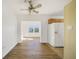 Bright living room showcasing wood-look flooring, ceiling fan and view to kitchen at 22220 Lasalle Rd, Port Charlotte, FL 33952