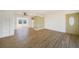 Bright living room showcasing wood-look flooring and a view to another room at 22220 Lasalle Rd, Port Charlotte, FL 33952