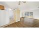 Bright living room showcasing wood-look flooring, ceiling fan, and kitchen view at 22220 Lasalle Rd, Port Charlotte, FL 33952