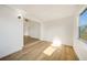 Bright and airy living room features wood floors and a window for natural light at 22220 Lasalle Rd, Port Charlotte, FL 33952