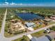 Stunning aerial view of the property with the property lines, the lake and the surrounding landscape at 2244 Meetze St, Port Charlotte, FL 33953