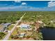 Aerial view of the property showcasing lush landscaping, serene lake frontage, and defined property lines at 2244 Meetze St, Port Charlotte, FL 33953