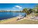 Scenic waterfront backyard with a charming bench to enjoy the lake view at 2244 Meetze St, Port Charlotte, FL 33953