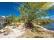 Lush backyard landscape with vibrant plants, a seating area, and serene lake views at 2244 Meetze St, Port Charlotte, FL 33953