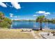 Scenic backyard view with a tranquil lake and seating area, perfect for relaxation at 2244 Meetze St, Port Charlotte, FL 33953