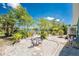 Serene backyard featuring a bistro table and beautiful landscaping with a pond view at 2244 Meetze St, Port Charlotte, FL 33953