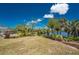 Large backyard with established landscaping, lawn, and direct access to the pond at 2244 Meetze St, Port Charlotte, FL 33953