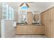 Light-filled bathroom featuring dual sinks, granite countertops, lots of storage, and glass block window at 2244 Meetze St, Port Charlotte, FL 33953