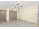 Bedroom featuring neutral-colored walls, tile flooring, a ceiling fan, and a double door closet at 2244 Meetze St, Port Charlotte, FL 33953