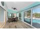 Cozy dining area with backyard pool views through large sliding glass doors, seating four around a wooden table at 2244 Meetze St, Port Charlotte, FL 33953