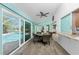 Dining area features backyard pool views through large sliding glass doors and an opening to the kitchen at 2244 Meetze St, Port Charlotte, FL 33953