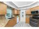 Well-lit kitchen featuring granite countertops, modern appliances, and ample cabinet space, ideal for culinary enthusiasts at 2244 Meetze St, Port Charlotte, FL 33953
