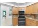 Kitchen area with light wood cabinets, stainless appliances, and granite counters, offering a stylish and practical cooking space at 2244 Meetze St, Port Charlotte, FL 33953