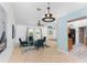 Cozy living room featuring blue chairs, tile floors, and a stylish chandelier creating a comfortable and inviting atmosphere at 2244 Meetze St, Port Charlotte, FL 33953