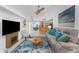 Bright living room featuring vaulted ceilings, modern decor, and an open layout to the kitchen and dining area at 2244 Meetze St, Port Charlotte, FL 33953