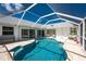 Enclosed pool area offering a refreshing escape and relaxing lounge area at 2244 Meetze St, Port Charlotte, FL 33953