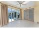 Bright sunroom with tile flooring, ceiling fan, and view of the screened-in pool area at 2244 Meetze St, Port Charlotte, FL 33953