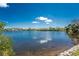 Picturesque lake view with lush shoreline vegetation, creating a tranquil natural setting at 2244 Meetze St, Port Charlotte, FL 33953