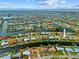 Aerial view of a waterfront community with single-Gathering homes situated along canals, with ocean views in the background at 2310 El Cerito Ct, Punta Gorda, FL 33950