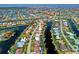 An aerial view shows the property situated along a waterfront canal in a neighborhood of single-Gathering homes at 2310 El Cerito Ct, Punta Gorda, FL 33950