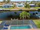 Stunning aerial view of a waterfront property with a screened-in pool and access to a canal at 2310 El Cerito Ct, Punta Gorda, FL 33950