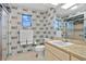 Retro bathroom with patterned walls, a window, and a glass shower enclosure at 2310 El Cerito Ct, Punta Gorda, FL 33950