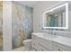 Modern bathroom with blue marble tile, sleek vanity, and a frameless glass shower door at 2310 El Cerito Ct, Punta Gorda, FL 33950
