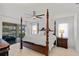 Spacious bedroom with a four poster bed and access to a screened-in porch at 2310 El Cerito Ct, Punta Gorda, FL 33950