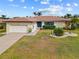 Charming single-story home with a well-manicured lawn, tasteful landscaping, and a two-car garage at 2310 El Cerito Ct, Punta Gorda, FL 33950