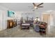Cozy living room showcasing marble floors, a large sectional sofa, and natural light from the window at 2310 El Cerito Ct, Punta Gorda, FL 33950