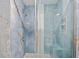 Bathroom shower featuring blue marble tiling and a built-in corner seat at 2310 El Cerito Ct, Punta Gorda, FL 33950