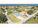 Aerial view of single Gathering home surrounded by homes, green space, and a canal in residential area at 24294 Santa Inez Rd, Punta Gorda, FL 33955