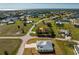 Aerial view of neighborhood with many homes, water features, with the home's location circled in red at 24294 Santa Inez Rd, Punta Gorda, FL 33955