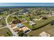 Aerial view of neighborhood with many homes, water features, with the home's location circled in red at 24294 Santa Inez Rd, Punta Gorda, FL 33955