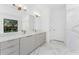 Bathroom featuring a double vanity with modern fixtures and marble accents at 24294 Santa Inez Rd, Punta Gorda, FL 33955