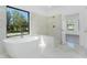 A luxurious bathtub is featured in this bright bathroom complete with a shower and large window at 24294 Santa Inez Rd, Punta Gorda, FL 33955