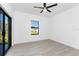 Bright bedroom with tile floors, ceiling fan, and sliding glass doors to bring the outside in at 24294 Santa Inez Rd, Punta Gorda, FL 33955