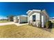 Beautifully landscaped property featuring stone accents and a three car garage at 24294 Santa Inez Rd, Punta Gorda, FL 33955