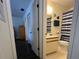 Bright bathroom features a vanity, toilet, and shower with blue striped curtain at 25068 Harborview Rd # 3D, Punta Gorda, FL 33980