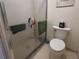 Bright bathroom with white toilet and updated shower at 25068 Harborview Rd # 3D, Punta Gorda, FL 33980